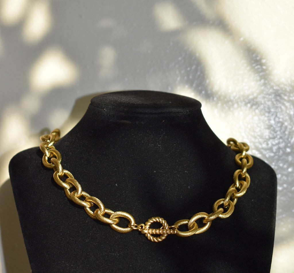 Chunky gold necklace with a toggle clasp closure
