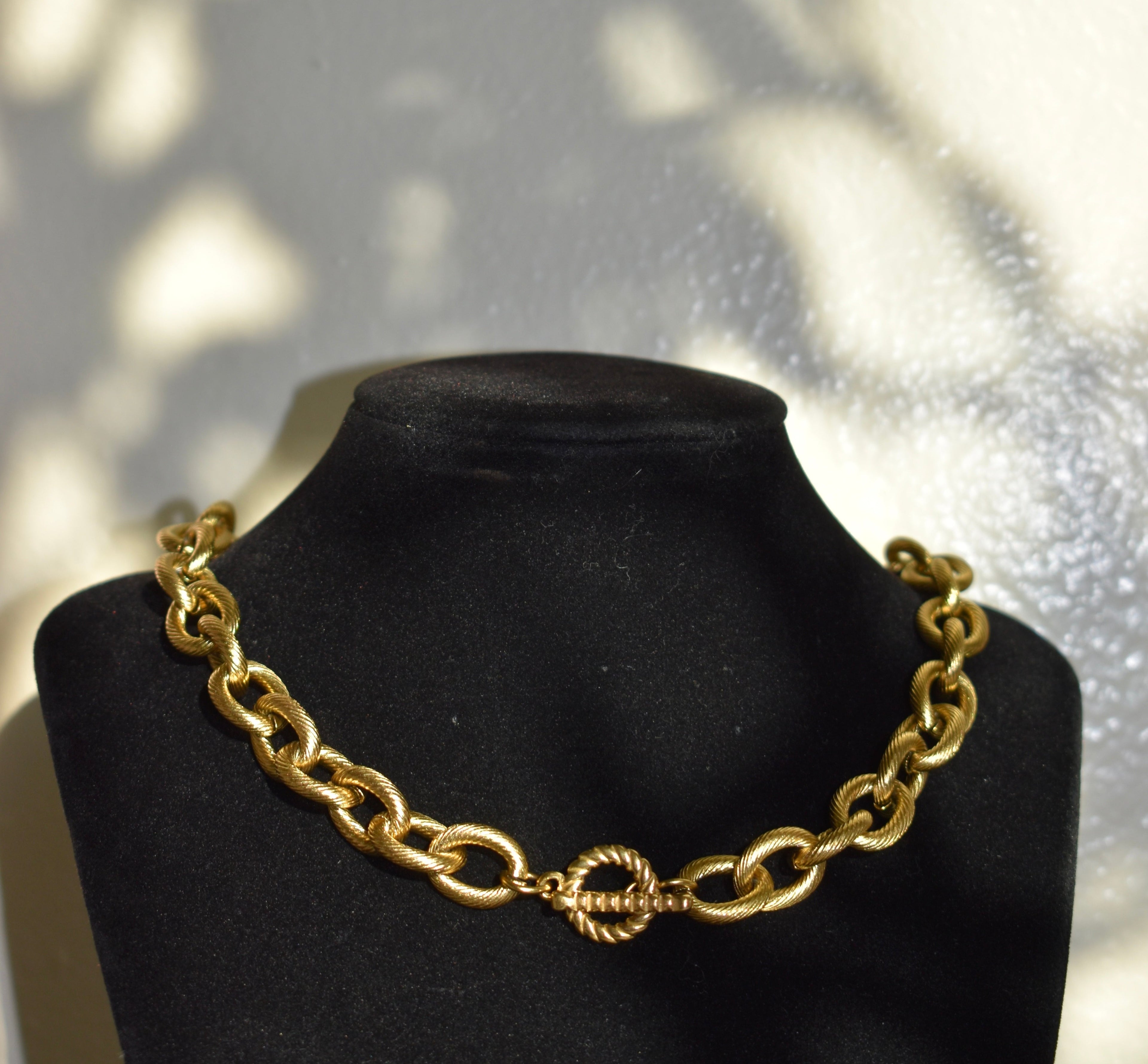 Chunky gold necklace with a toggle clasp closure